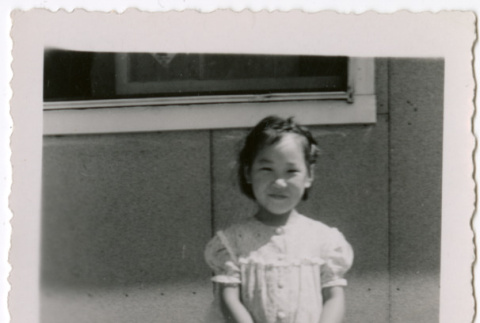 Girl standing outside barracks (ddr-densho-329-1320)