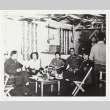Six people sitting around a decorated room (ddr-densho-259-705)