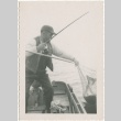 Man on boat bringing in catch (ddr-densho-326-13)