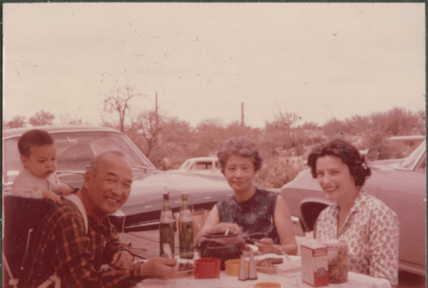 Chester, Agnes and Tina Sakura with baby at a picnic (ddr-densho-523-413)