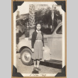 Girl stands next to a car (ddr-densho-542-210)