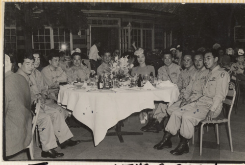 Nine men and a woman sitting at a table ato Tavern on the Green (ddr-densho-466-419)