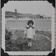 A girl standing in front of a fence (ddr-densho-300-511)