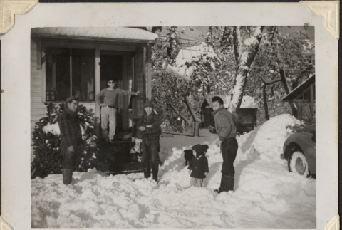Four men and child outside of house in snow (ddr-densho-466-878)
