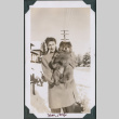 Photo of a woman holding a dog in snow (ddr-densho-483-1278)