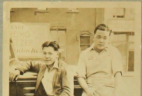 Men sitting on a car (ddr-densho-258-10)