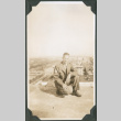 Man kneeling on rooftop (ddr-ajah-2-718)