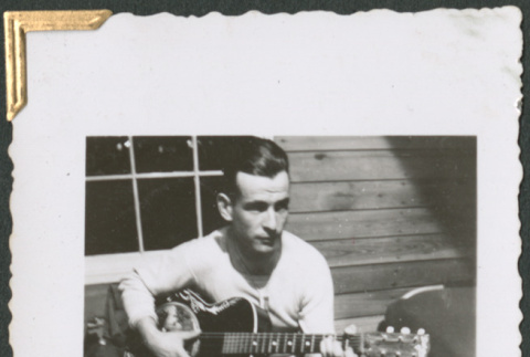 Man playing guitar (ddr-densho-434-43)