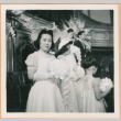 Helen Takahashi looking at camera, wedding party in background (ddr-densho-410-483)