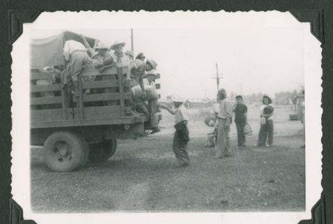 Men loading into a truck (ddr-densho-471-34)