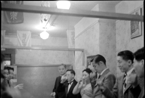 Group standing for a toast at banquet table (ddr-densho-426-2024)