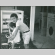 Girl on tricycle with older boy (ddr-densho-523-579)