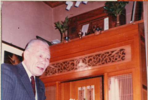 Hisamiysu Ojisan standing by altar (ddr-densho-426-2232)