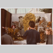 Man standing by flower display (ddr-densho-329-1201)