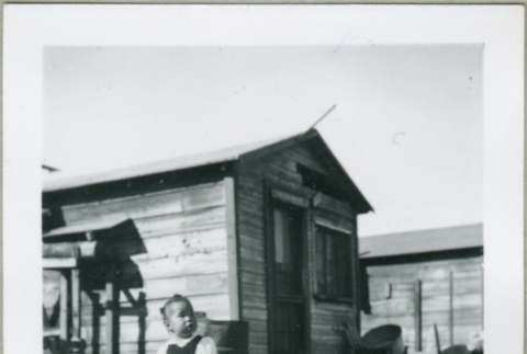 A toddler in front of MacDonald Hill cabins (ddr-densho-300-71)