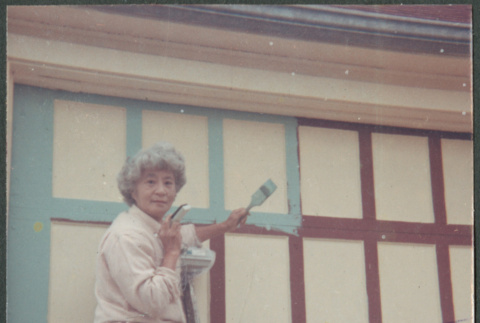 Agnes Sakura painting garage trim (ddr-densho-523-325)