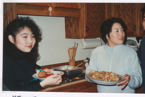 People eating in kitchen (ddr-densho-477-645)
