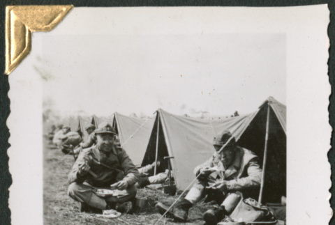 Men sitting in bivouac tents eating (ddr-densho-434-63)