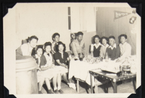 Group of young adults around a table (ddr-densho-542-669)