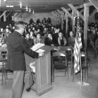 Man at podium addressing crowd (ddr-densho-1007-462)