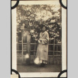 Tomoye (Nozawa) Takahashi by flowering trees (ddr-densho-423-519)