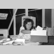 Woman sorting through papers (ddr-densho-1007-562)