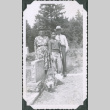 Photo of a man, woman, and child by a gravestone (ddr-densho-483-1223)