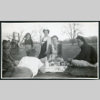Photograph of a group of people enjoying Sunday dinner as a picnic at Manzanar (ddr-csujad-47-282)
