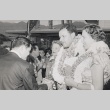 Couple wearing leis being welcomed at the Honolulu Airport (ddr-njpa-2-223)