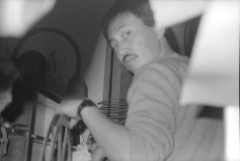 Man with film reels (ddr-densho-1007-559)
