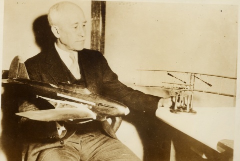 A man holding model airplanes (ddr-njpa-1-2590)