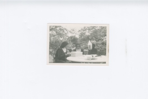 (Photograph) - Image of three nuns seated at table (ddr-densho-330-273-master-ff3d6d59a3)