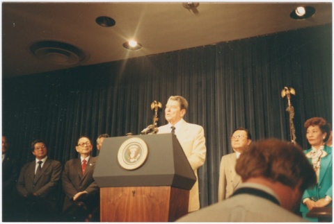 President Ronald Reagan speaking at the signing of the Civil Liberties Act of 1988 (ddr-densho-10-174)