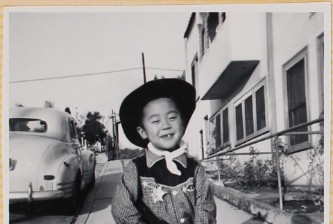 William Shiomi in cowboy costume with toy gun (ddr-densho-522-259)