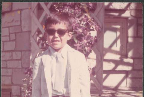 Boy in sunglasses and suit, carrying violin case (ddr-densho-523-586)