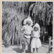 Susan Shiomi in costume headdress with actor wearing indigenous costume (ddr-densho-522-595)