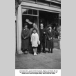 Two men, two women and girl standing outside shop (ddr-ajah-6-372)