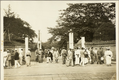 Men standing around a gateway (ddr-njpa-13-1265)