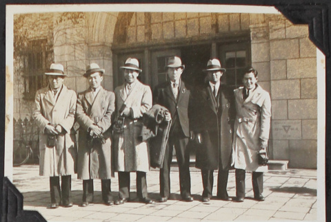 Group of 6 men standing in front of building (ddr-densho-326-340)