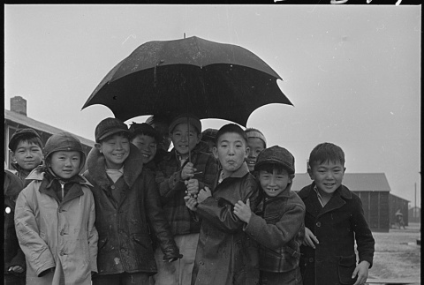 Japanese American children in the rain (ddr-densho-37-628)