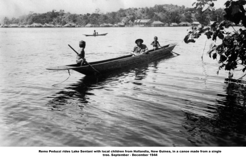 Man and two children in canoe (ddr-ajah-2-820)