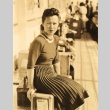Woman sitting on a suitcase (ddr-njpa-4-19)
