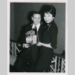 Mary Mon Toy with man holding album soundtrack for The World of Suzie Wong film (ddr-densho-367-189)