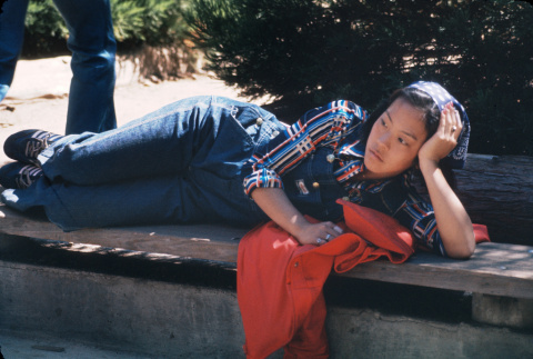 Margie Yemoto laying on a bench (ddr-densho-336-811)