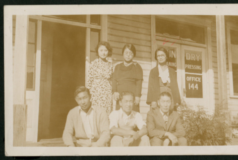 Group pose in front of dry cleaners (ddr-densho-359-123)