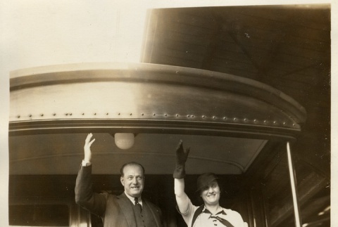 A couple waiving from the back of a train (ddr-njpa-1-2158)