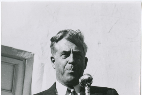 Man standing at microphone (ddr-densho-426-1038)