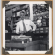 Man leaning on a counter (ddr-densho-542-105)