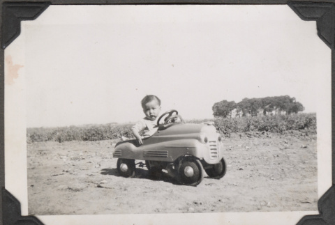 Young boy in toy car (ddr-densho-466-206)