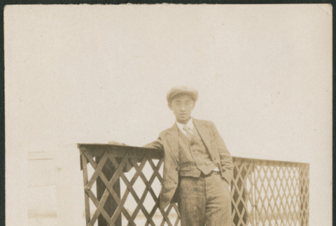 Man leaning on metal railing (ddr-densho-316-276)